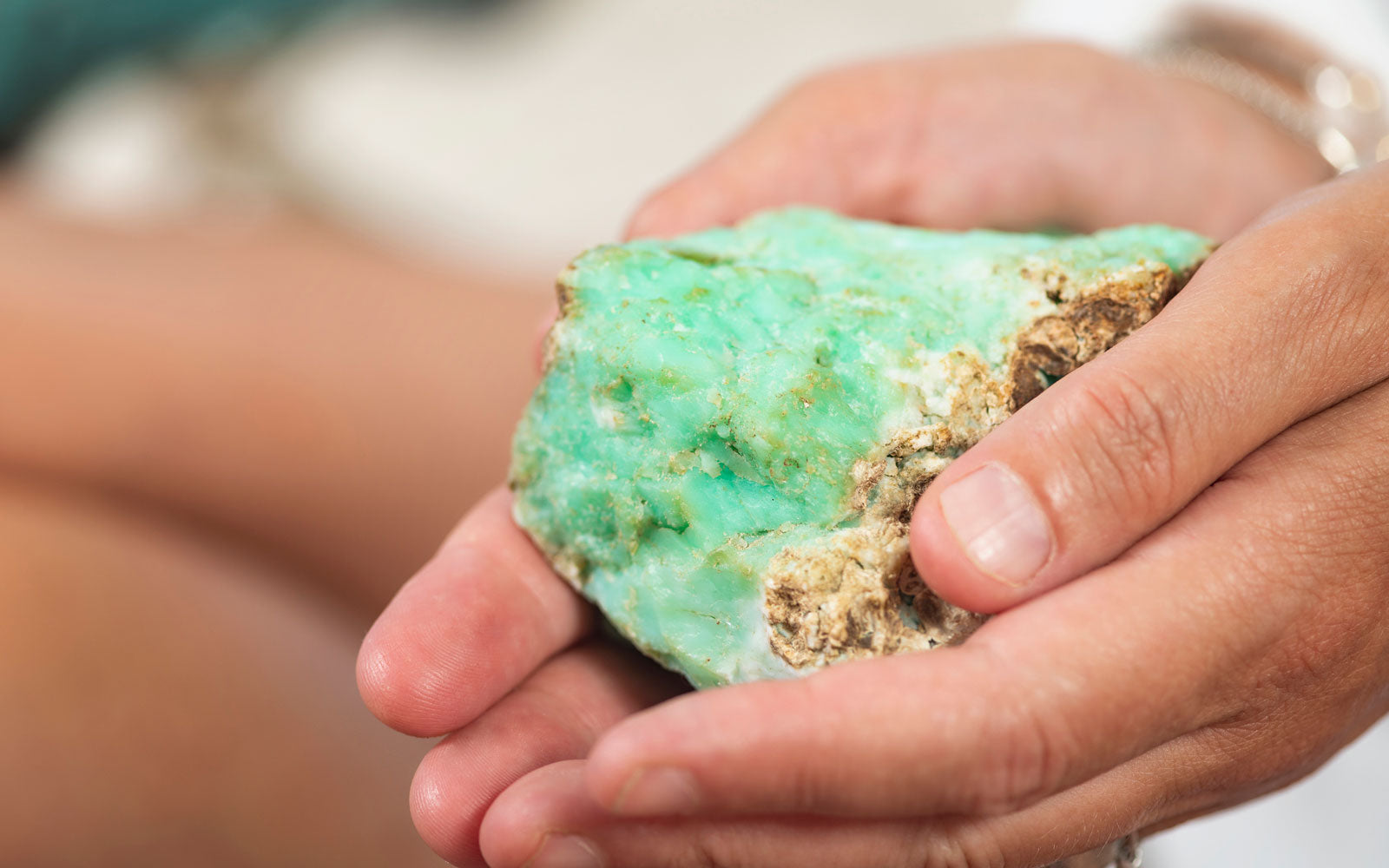 Person holding a large chrysoprase stone