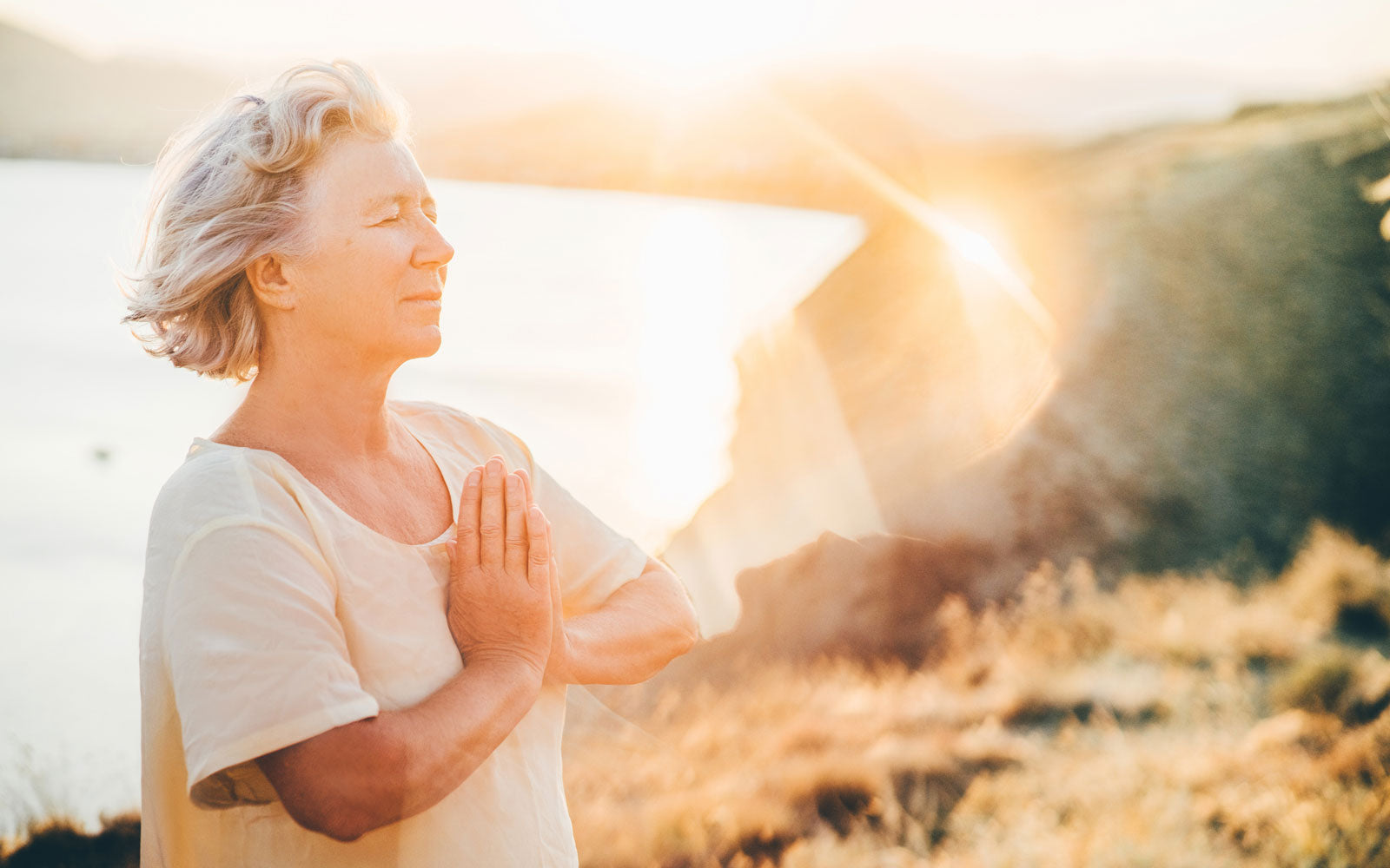 Woman soaking in the sun while meditating