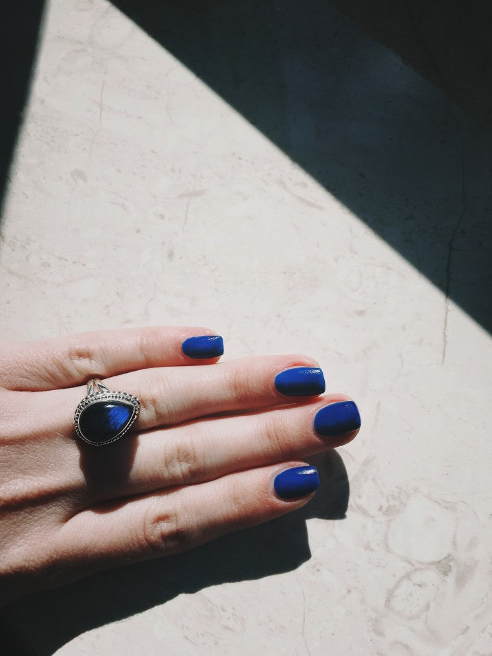 woman wearing blue labradorite ring