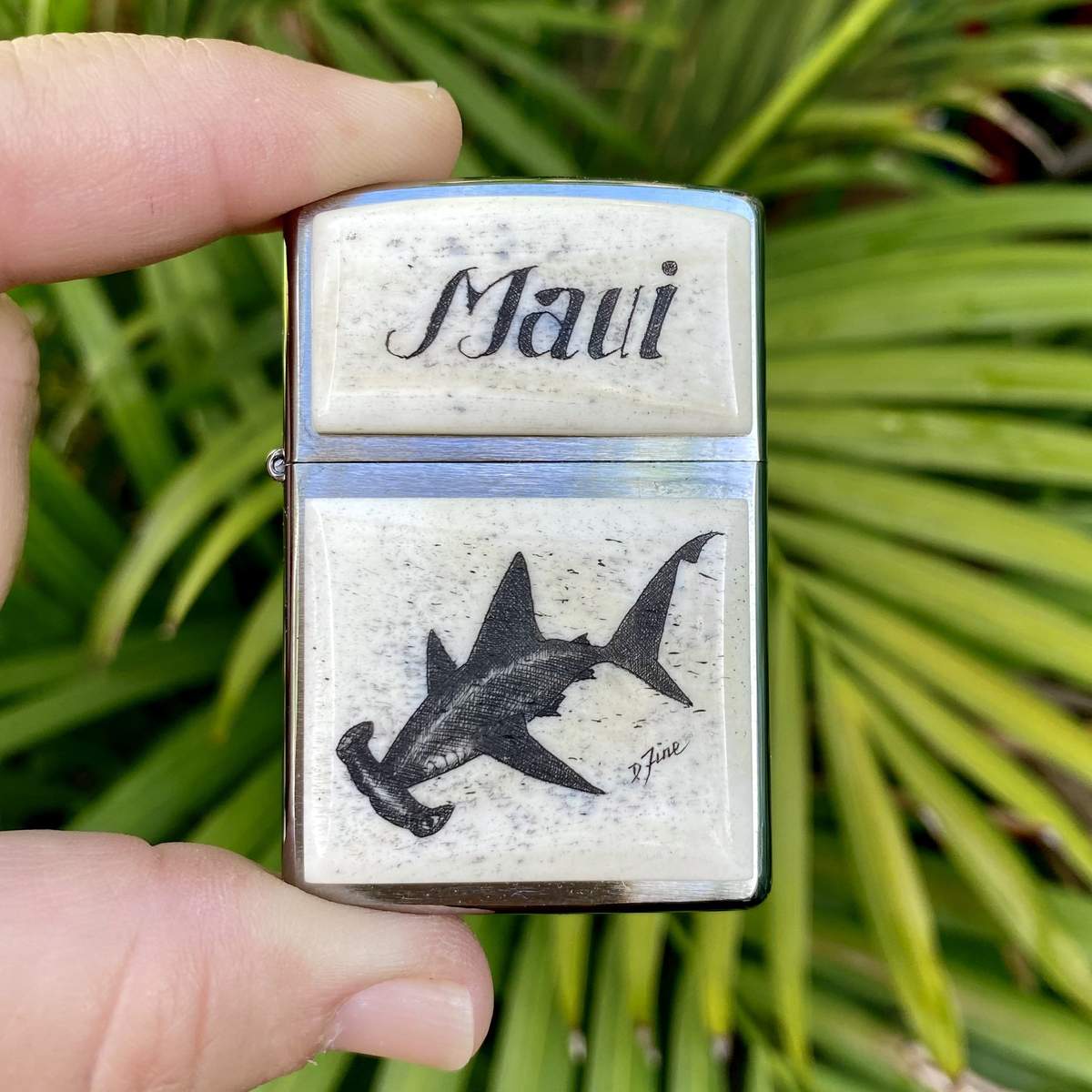 Scrimshaw zippo lighter with hammerhead shark on it