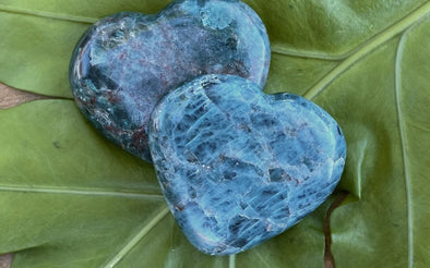 Apatite heart stone on wooden surface