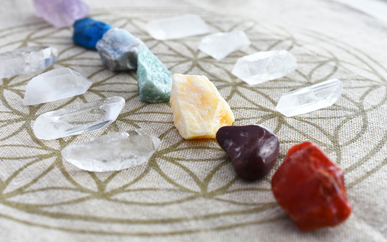 Chakra stones lined up on a chart