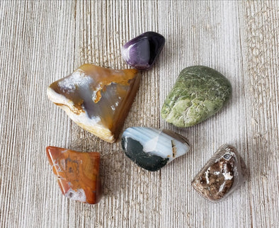 Healing crystals with jasper on a wood surface