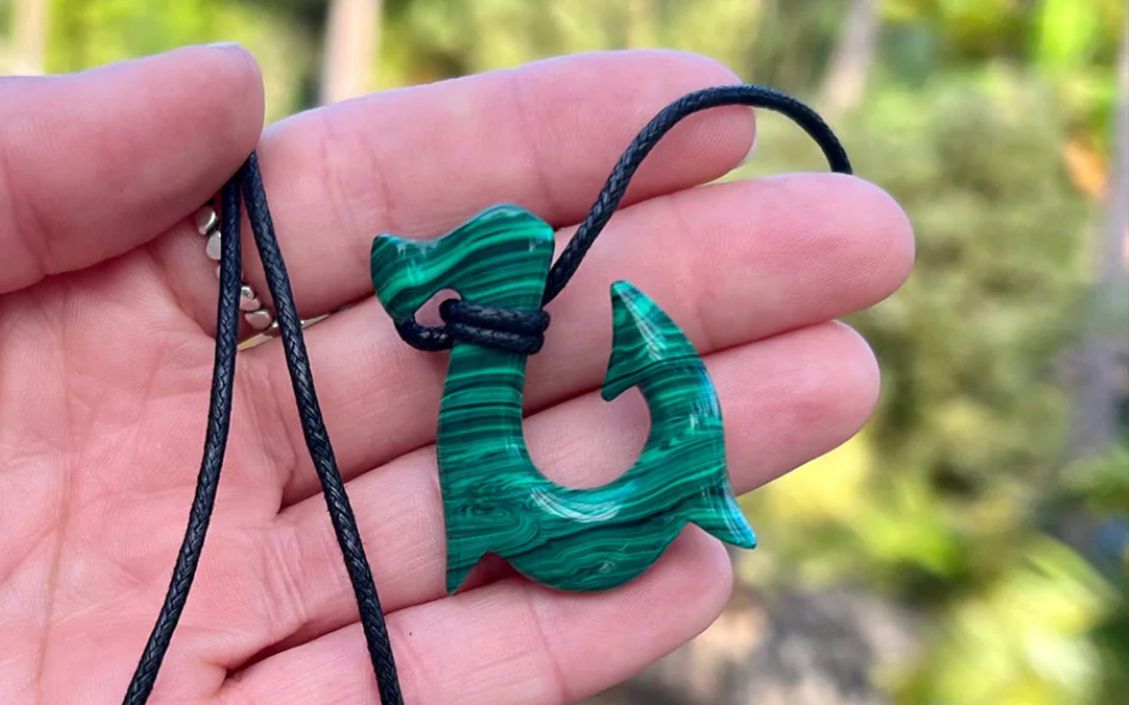 Person holding Malachite Maui Fish Hook Necklace