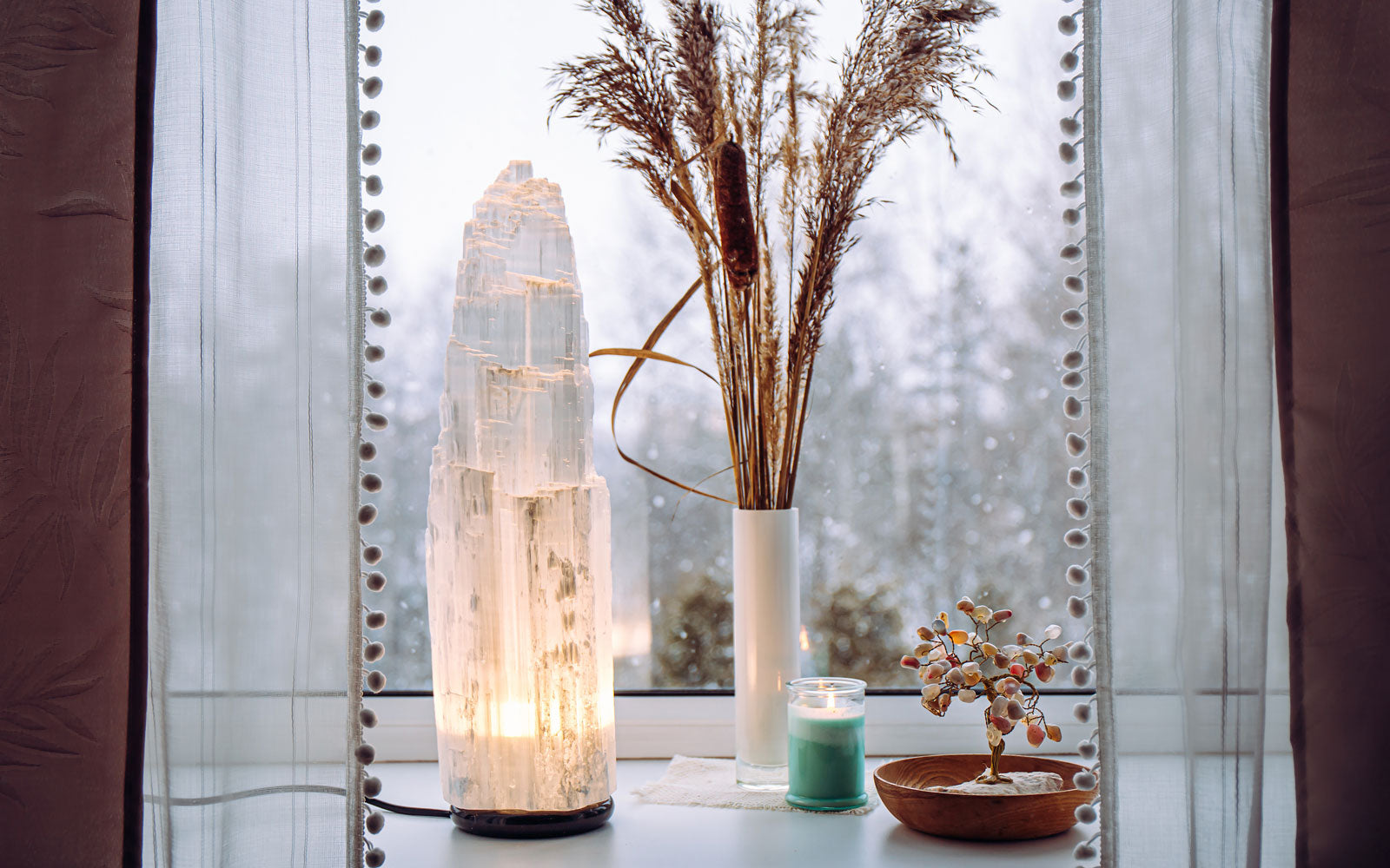 Large selenite crystal lamp in a window sill