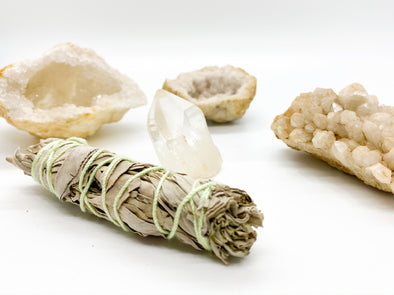 sage and crystals on a white background