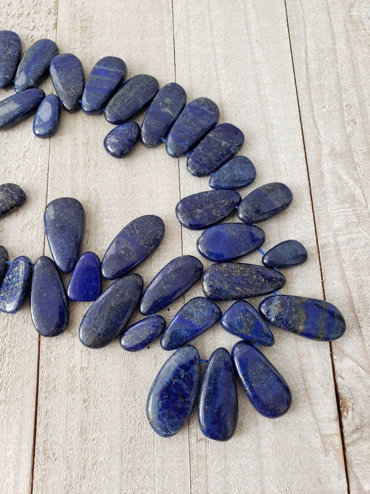 Lapis Lazuli stones arranged on wood planks