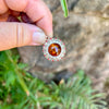 Person Holding Honey Baltic Amber Sterling Silver Pendant with Gemstone Detail