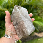 Person holding Large Polished Smoky Quartz Crystal Point with healing properties