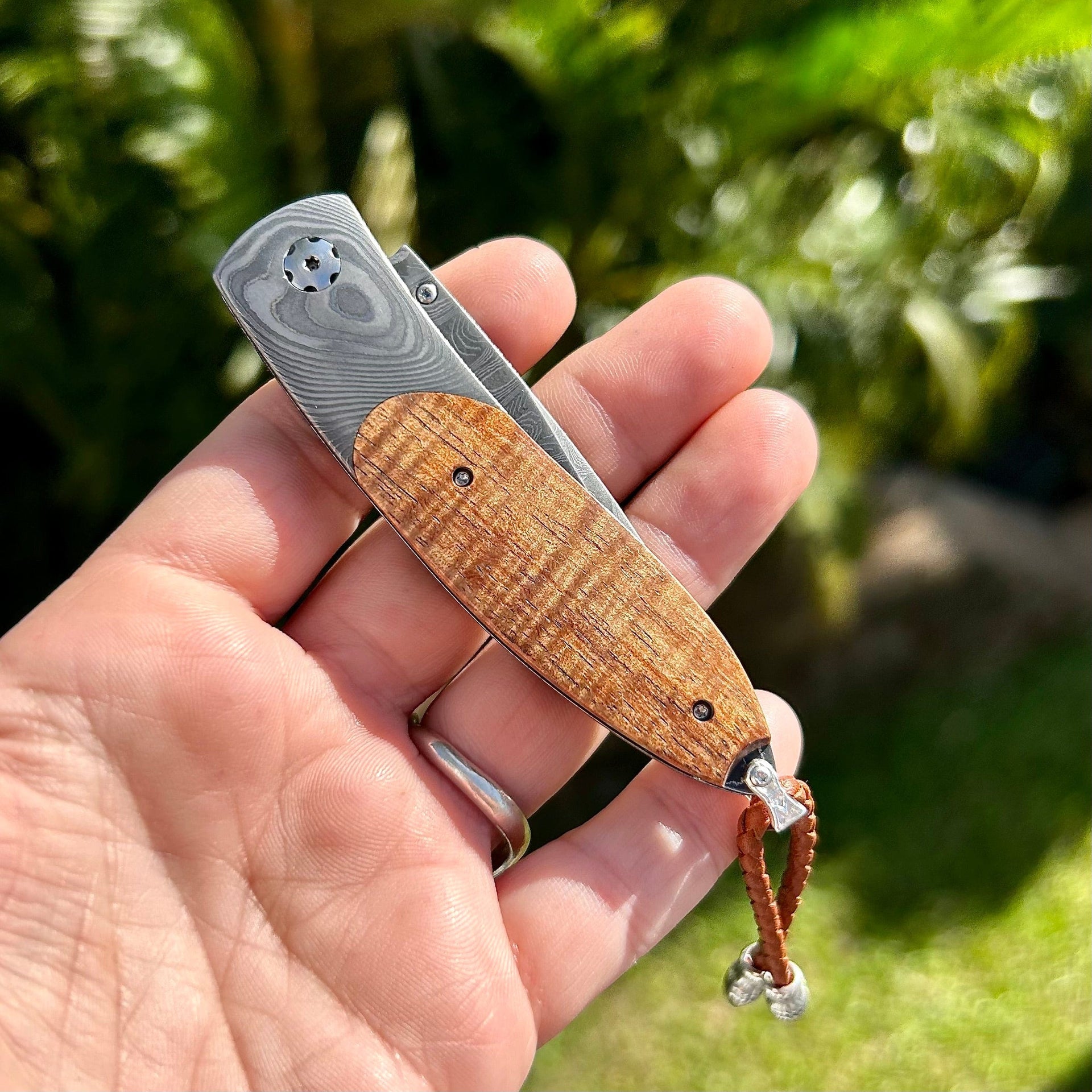 Closed William Henry Damascus Knife Inlaid with Curly Koa Wood