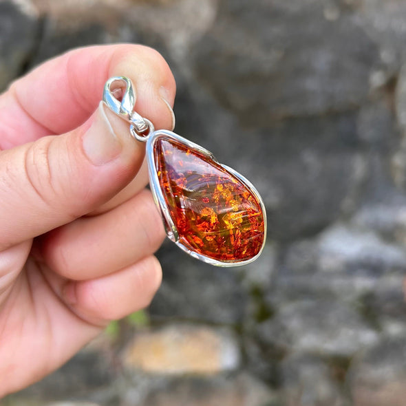 Person Holding Baltic Amber Sterling Silver Pendant Frame