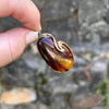 Person Holding Baltic Amber Teardrop Pendant with Gold Vermeil