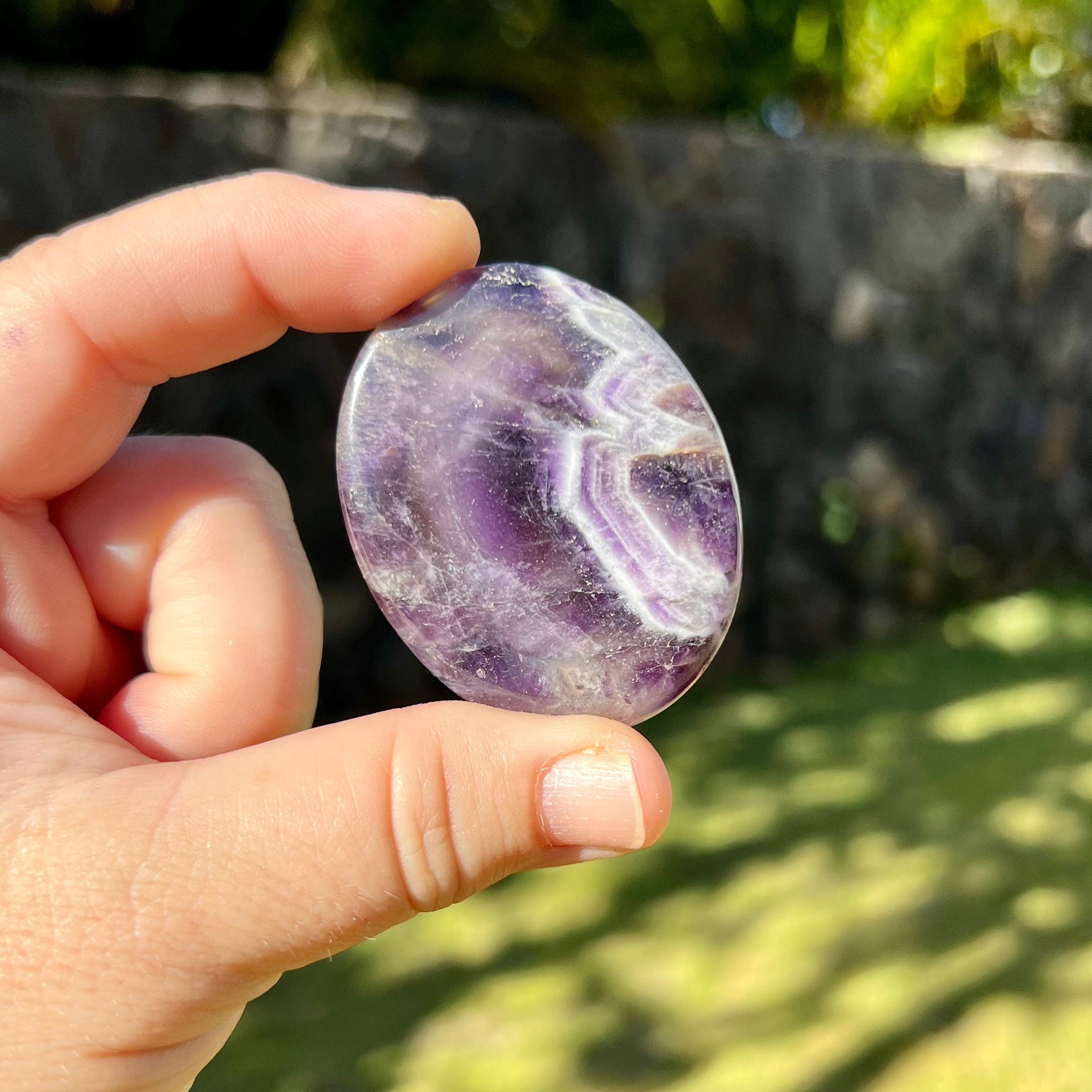 Hand Holding Chevron Amethyst Worry Stone